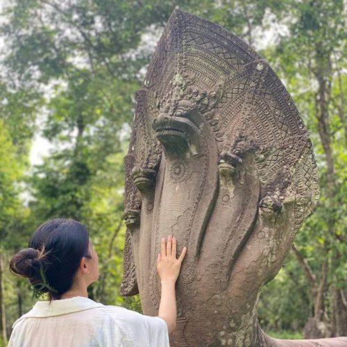 Soft touch the naga head at Beng Mealea temple on 2-Day Lost City of Koh Ker, Beng Mealea & Floating villages Tour by siemreapshuttle.com